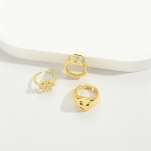 Three-piece gold adjustable ring set with star, moon and alien engraved gemstone motifs