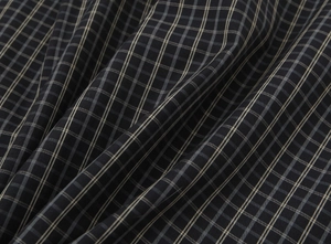 Macro detail of high-quality grey plaid cotton fabric showing fine weaving texture