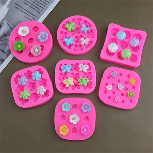 Pink silicone molds showing flower, bow, and shell shapes for cake and chocolate decorating