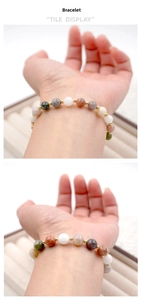 Macro detail of multi-colored natural stone beaded bracelet with golden metal spacers