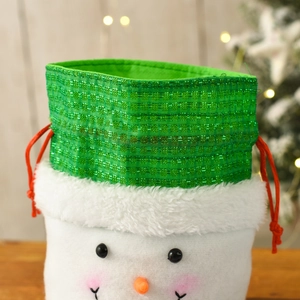 Close-up of a snowman Christmas gift bag with a green sequin top and red drawstring
