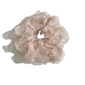 Pink sheer organza ruffled scrunchie hair tie with layered lace design on white background