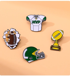 Close-up of four American football enamel pins showing helmet, jersey, and trophy