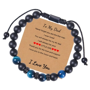 Detail of beaded bracelets with tiger eye and agate beads next to a Dad greeting card