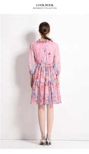 Back view of a pink floral chiffon dress with butterfly prints and elastic waist design