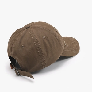 Distressed brown cotton baseball cap with torn details and adjustable metal buckle