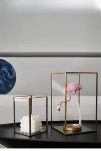 Detail of vintage gold brass frames and clear glass panels on minimalist storage display boxes