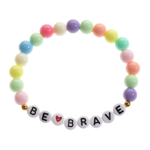 Detail shot of colorful beaded bracelet with BE BRAVE letter charms and golden accents