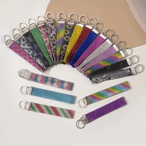 Detail showing various rhinestone webbing keychains with shiny polished silver metal rings