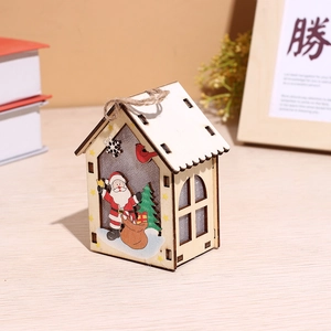 Close-up of wooden Christmas house with Santa and reindeer motifs and a hanging rope