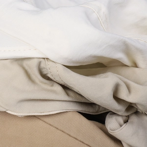 Detailed close-up of multiple colored twill cotton fabrics showing fine stitching and texture