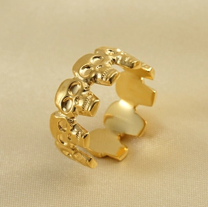 Detailed macro view of 18k gold plated stainless steel ring with gothic skull reliefs