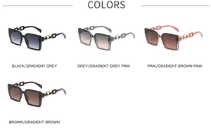 Macro detail of oversized square sunglasses featuring unique chunky chain temple designs