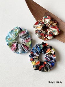 Detailed view of three printed fabric yoga headbands with floral and butterfly patterns