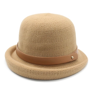 Beige knitted bucket hat with brown leather buckle strap and metal rivet detail