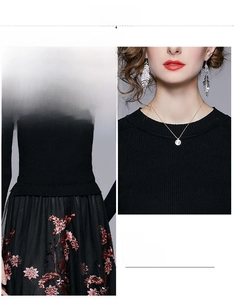 Close-up of vintage heavy embroidery floral pattern on black mesh skirt detail