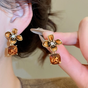 Detail showing amber zircon flower drop earrings with 18K gold plated vintage finish