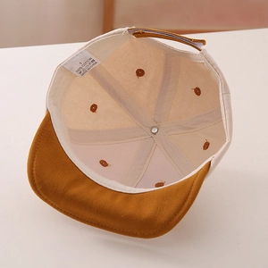Internal detail of a 100% cotton toddler baseball cap showing quality stitching and label