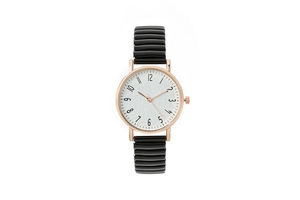 Detail of elegant gold-tone watch case and white textured dial with black stretch band