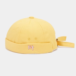 Detailed close-up of yellow canvas docker hat featuring 3D lit letter embroidery