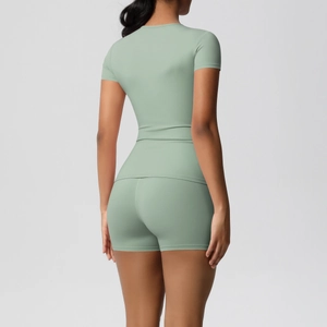 Rear view detail of sage green athletic yoga set featuring fitted t-shirt and slim shorts