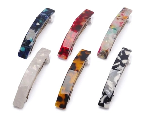 Close-up of rectangular acetate hair clips in marble and tortoiseshell patterns
