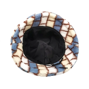 Detail of lamb wool bucket hat with checkerboard pattern and adjustable inner strap