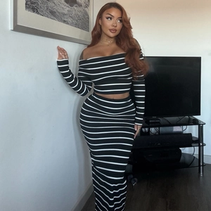 Detail of off-shoulder striped crop top and bodycon maxi skirt set in black and white