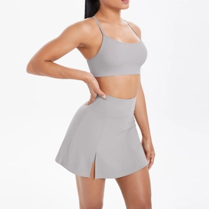 Vue latérale d'un ensemble de tennis gris avec brassière et jupe à taille haute
