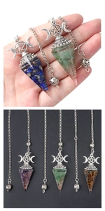 Detailed macro view of triple moon goddess crystal pendulums with spiral wire wrap