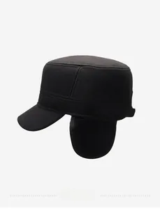 Detail of black flat top winter hat featuring metal logo plate and warm ear flaps