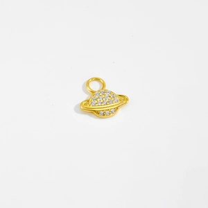 Detailed view of a golden planet-shaped pendant with sparkling white cubic zirconia
