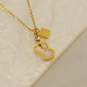 Close-up of golden bunny necklace with mother-of-pearl inlay and lucky character charm