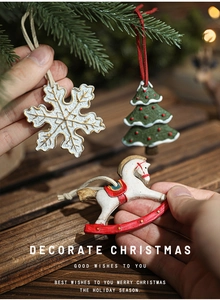 Detail of vintage hand-painted resin Christmas ornaments with snowflake and tree motifs