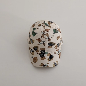 Detail of cute bear print on beige cotton baseball cap with circular leather logo patch