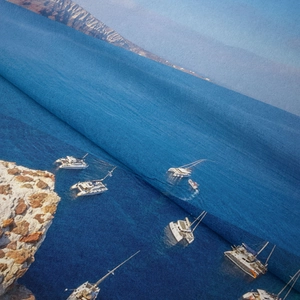 Detailed macro view showing the fine fabric texture and Santorini ocean print of the tapestry