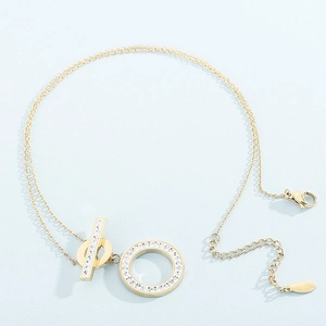 Elegant gold stainless steel necklace with diamond-encrusted OT buckle pendant on blue surface