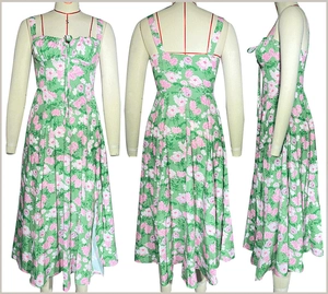 Three-way view of a floral green sleeveless sun dress with a side slit on a dress form