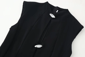 Close-up of black sleeveless dress with rhinestone accents and silver metal zipper
