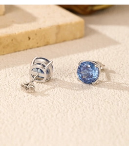 Macro view of blue rose-cut crystal stud earrings in 925 sterling silver four-prong setting