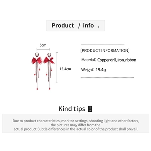 Detailed view of red bow earrings with rhinestones and tassels including size specifications