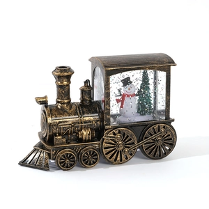 Vintage bronze Christmas train lantern featuring snowman and tree decorations