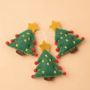 Three green wool felt Christmas tree ornaments with red pom-poms and yellow stars