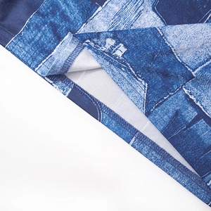 Detailed macro view of the double-needle hem stitching and blue denim print fabric