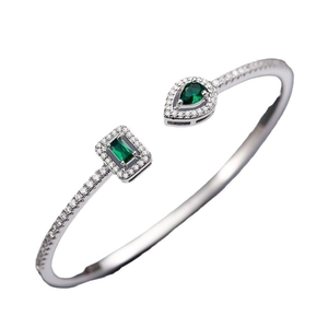 Silver adjustable cuff bracelet with green rectangular and pear-shaped crystals