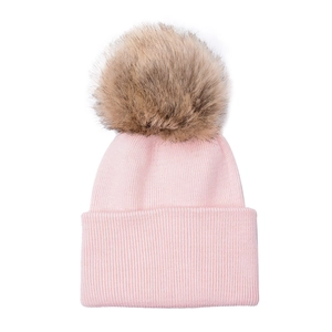 Close-up of pink knit baby beanie with large faux fur pompom and ribbed cuff detail