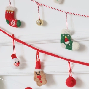 Handmade wool felt Christmas garland with Santa Claus, gingerbread man, and bells decoration