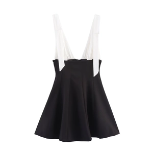 Chic black and white mini dress with bow detail and pleated wide straps in A-line cut