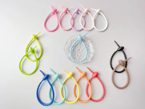 Macro detail of colorful silicone cable ties showing adjustable buckle and soft texture