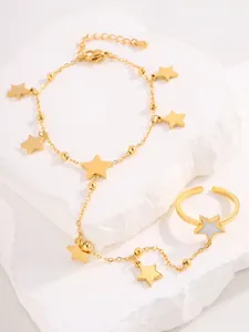 Detail of gold star slave bracelet with finger ring and adjustable lobster clasp